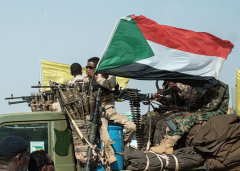 Members of the Rapid Support Forces on an armed vehicle, in the capital Khartoum.
