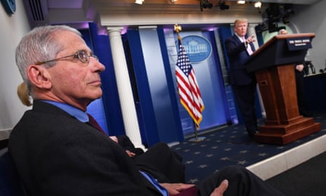 United States President Donald Trump stands as Director of the National Institute of Allergy and Infectious Diseases at the National Institutes of Health Dr Anthony Fauci listens during the Coronavirus Task Force briefing at the White House in Washington, DC.