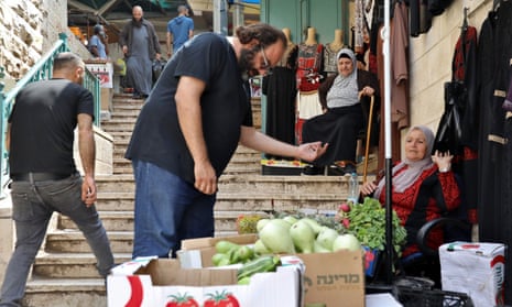 Chef Fadi Kattan talks to Un Nabil in the market of Bethlehem, West Bank.
