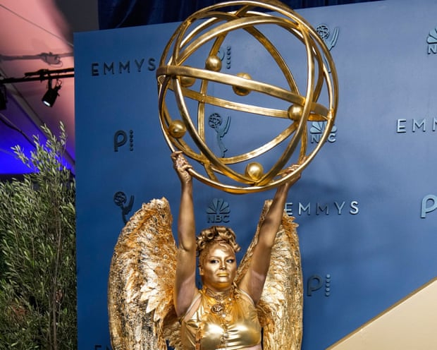 Meg Stalter dressed as an Emmy award