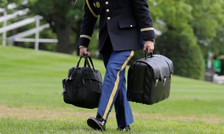 A military aide carries the nuclear football.