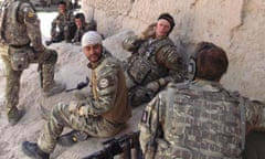 Interpreter Mohammad Hares, wearing a bandana, and Ed Aitken, centre, on duty in Afghanistan.