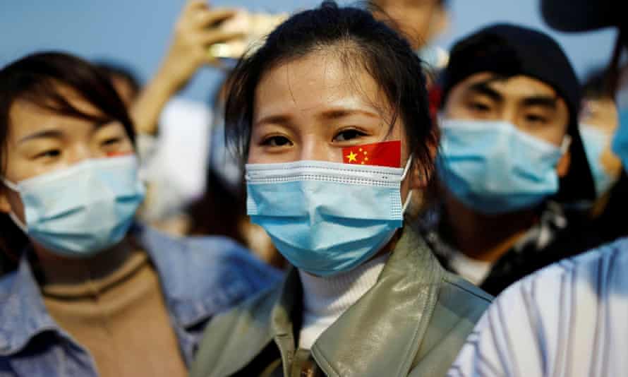 People wearing face masks at a Beijing ceremony to mark the 71st anniversary of the founding of People’s Republic of China in October.