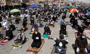 Supporters of Iraqi shia cleric Moqtada al-Sadr maintain social distancing as they attend Friday prayers for the first time in months