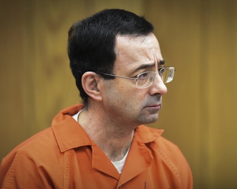 a man in prison attire looks ahead