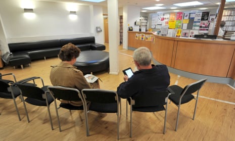 People sit and wait at a GP surgery