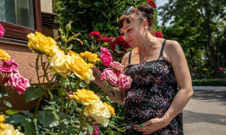 Pregnant Tamila looking at roses