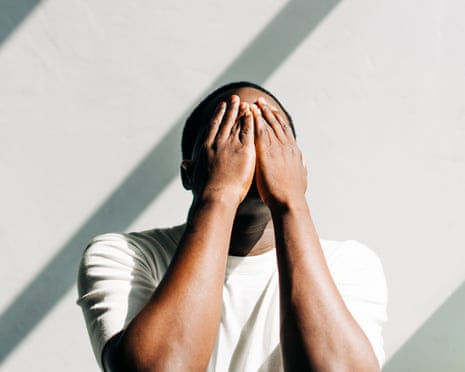 African American man tired and stressed, covered his face with his hands. Mental health, prevention of burnout and depression.