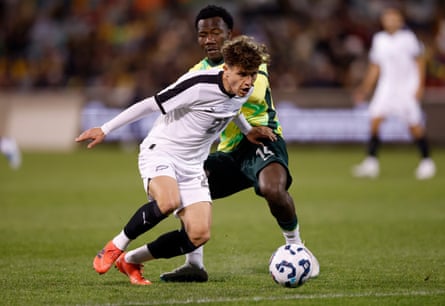 Callan Elliot shields the ball from Nestory Irankunda.