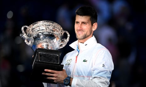 Novak Djokovic lifts the Norman Brookes Challenge Cup trophy for a 10th time on Rod Laver Arena.