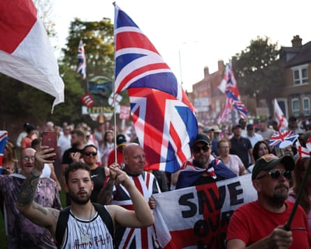 A crowd of protesters, some of them holding union flags