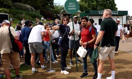 Spectators queue for tickets inside the grounds during day seven of Wimbledon