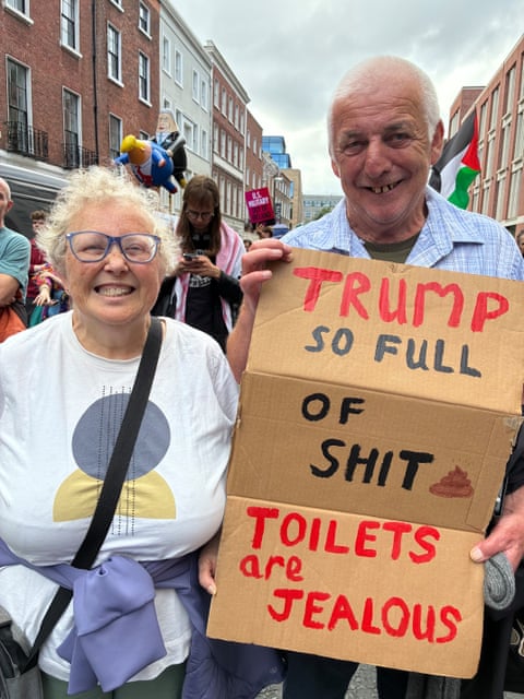Helen and Mick Brennan hold a banner in Dublin to protest Donald Trump’s visit to Ireland.
