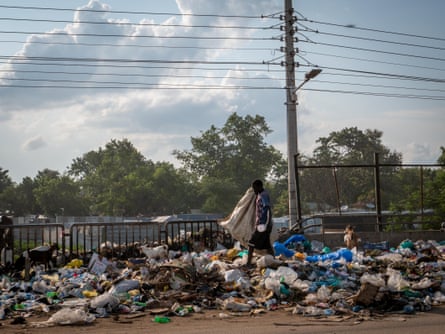 A man scours the rubbish at the side of the street in Konyo Konyo district, Juba,