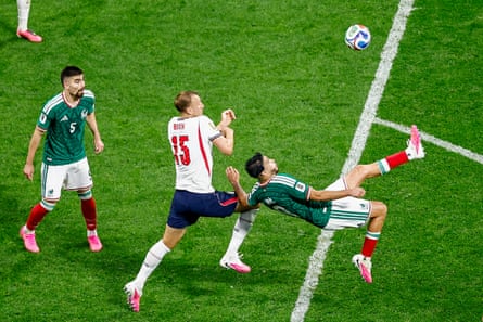 Mexico's forward Raúl Jiménez makes a bicycle kick as Dan Burn closes in