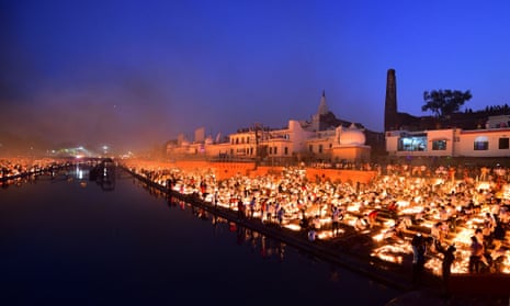 People light earthen lamps on the banks of the Sarayu River on the eve of Diwali in Ayodhya.