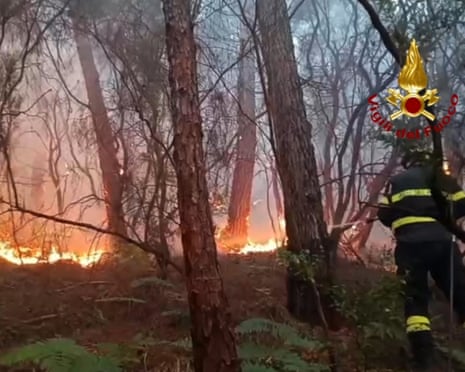 Firefighters trying to extinguish a major fire on Mount Faeta in the area between the provinces of Lucca and Pisa in the Tuscany region of Italy.