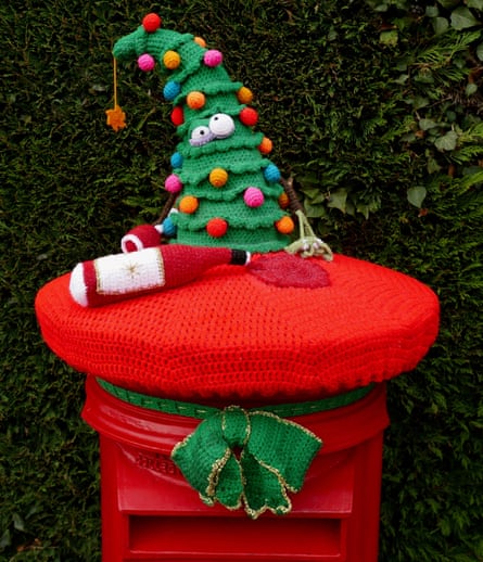 A Christmas-themed topper on a post box.