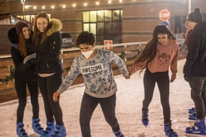A couple of Italian girls look on as Nazira and Fariba go ice-skating.