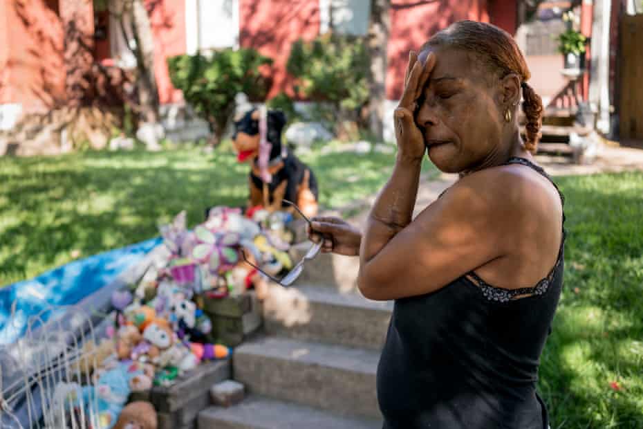 Tracy Wafford, wipes away tears as she stands next to a memorial for her 3-year-old granddaughter, Kennedi Powell, outside her house in south St. Louis.