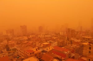 Oran, Algeria: The port city engulfed in a yellow cloud of dust during a sand storm.