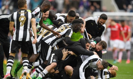 Newcastle players celebrate after Aston Villa’s late equaliser against Brighton gave them the title.