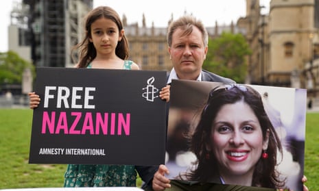 Nazanin Zaghari-Ratcliffe’s daughter and husband holding a picture of her in Parliament Square, London, last year.