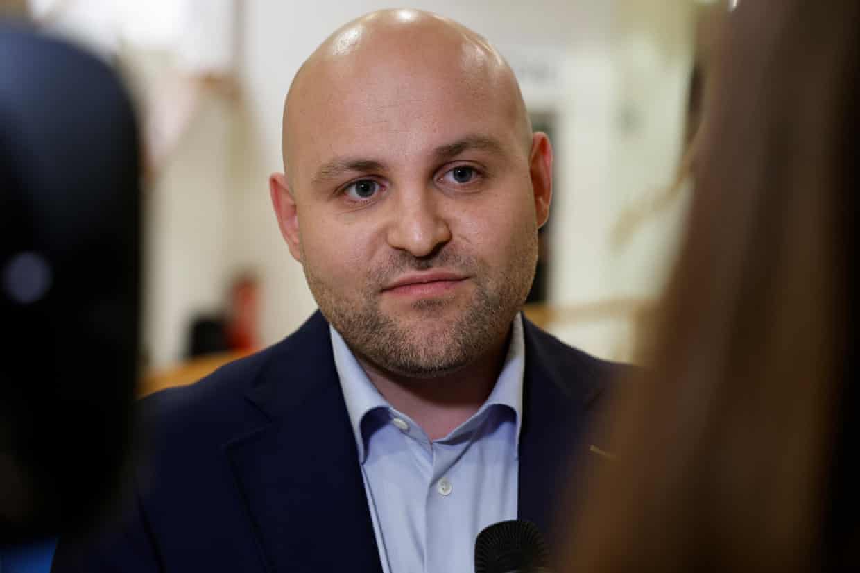 Markus Frohnmaier, AfD candidate, speaks into a microphone during a TV interview