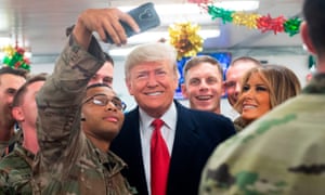 President Donald Trump and First Lady Melania Trump greet members of the US military during an unannounced trip to Al Asad Air Base in Iraq.
