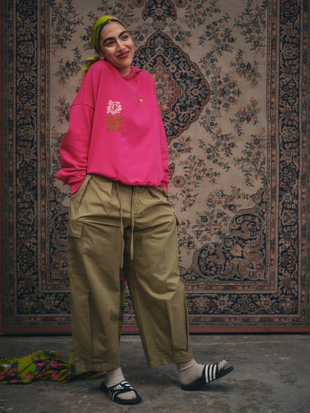 A pink sweatshirt and khaki green trousers from Nöl Collective’s autumn/winter 2023 collection.