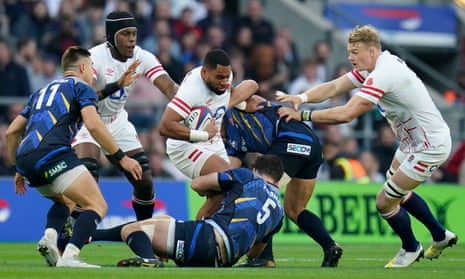England's Jack Nowell (centre) is held up bu the Japanese line.