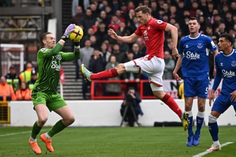 Pickford catches the ball under pressure from Wood.