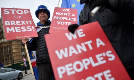Anti-Brexit demonstrators hold placards calling for a “People’s Vote” outside the Houses of Parliament.