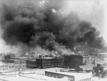 black and white image of smoke rising over buildings