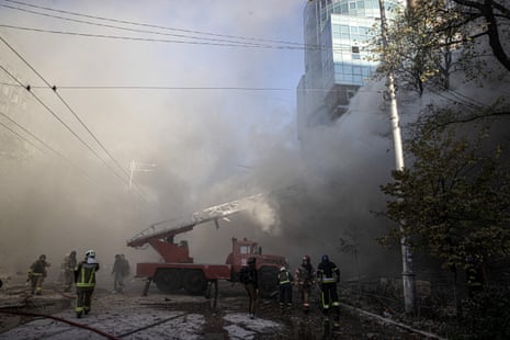 Firefighters conduct work in a destroyed building after the Russian drone attacks in Kyiv this morning.
