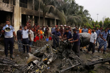 Firefighters work to remove wreckage.