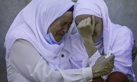 A daughter of a victim of Srebrenica genocide is hugged by her mother
