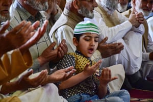 A boy offers congregational prayers inside the Grand mosque (Jamia Masjid) in Kashmir, India