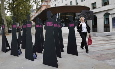 Cut-out silhouettes representing women set up outside the Metropolitan police headquarters in London by the domestic abuse charity Refuge