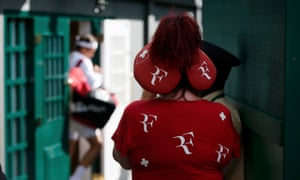 A fan of Roger Federer watches as he comes out for his match against Roberto Bautista Agut.