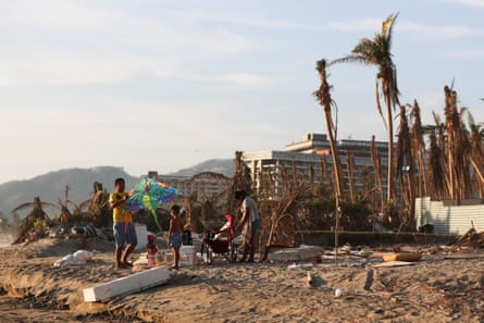 essay about mexico city A man holds a kite amid damaged palm trees on Punta Diamante beach a month after Hurricane Otis struck Acapulco.