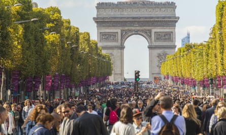 Thronged crowds enjoy the car ban at the Champs Elysées.