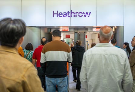 People waiting at arrivals at Heathrow terminal four