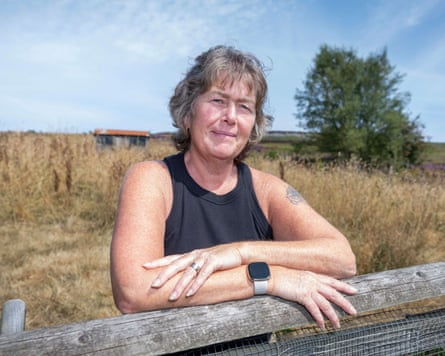 Cindy Rogers leaning on a fence