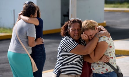 Relatives and friends of victims embrace each other outside the general prosecutor’s office in Veracruz, on 28 August.