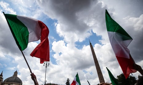 People wave Italian national flags at a joint rally staged by Italy’s three main rightwing parties, Lega, Brothers of Italy and Forza Italia, last year