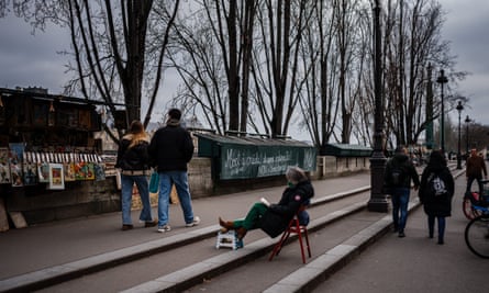 People look at bookstalls positioned along the Seine