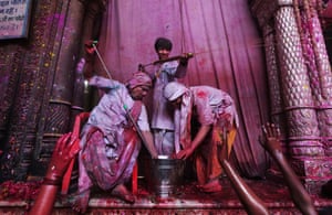  Hindu priests spray coloured water on devotees in Banke Bihari temple during Holi festival celebrations. 