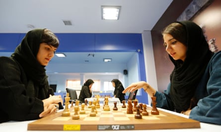 Iranian players Mitra Hejazipour, left, and Sara Khademalsharieh play at the Chess Federation in the capital Tehran, which will host the Women’s World Championship.
