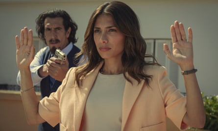 Evin Ahmad is held at gunpoint with her arms raised